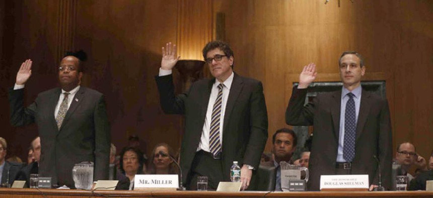 TIGTA J. Russell George, former Acting IRS Commissioner Steven Miller, and former IRS Commissioner Douglas Shulman give oaths before testifying in front of the Senate Finance Committee