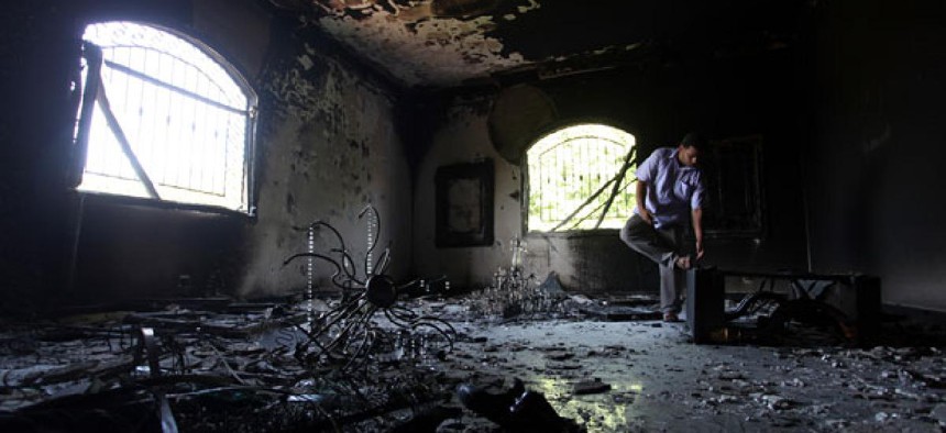 A Libyan man investigates the inside of the U.S. Consulate in Benghazi after the attack in September.