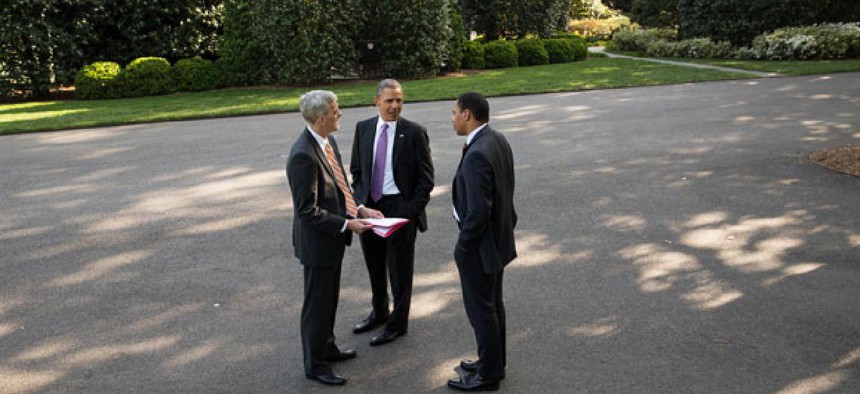 Barack Obama, Rob Nabors  and  Denis McDonough confer outside the White House.