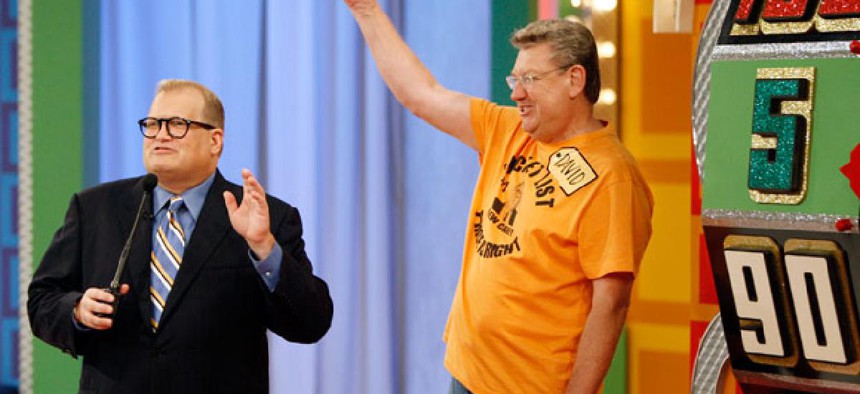 A contestant stands next to the "Big Wheel" during a taping of the Price is Right. When mail carrier Cathy Wrench Cashwell appeared on the same show, officials discovered she was more mobile than her workers compensation claims suggested. 