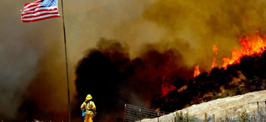 A firefighter watches a wildfire northeast of Castaic, Calif., in May.