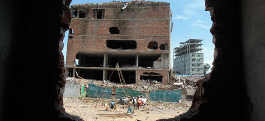 Laborers work at the site where a Bangladesh garment-factory building collapsed in April.