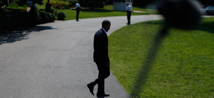 Barack Obama walks outside the White House in June.