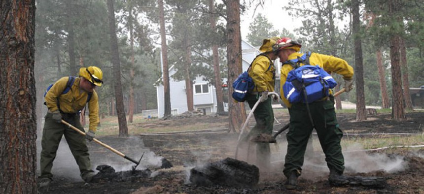Soldiers from the 1157th Engineer Firefighter Company, Colorado National Guard, smother hot spots near Colorado Springs.