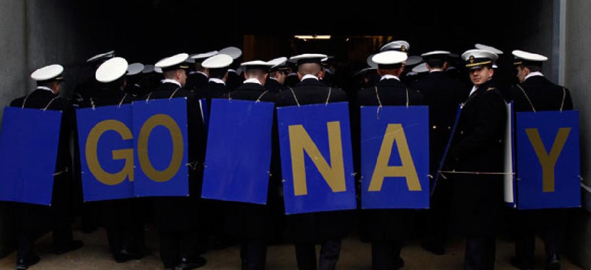 Navy Midshipmen march off the field before the start of the Army-Navy football game in December.
