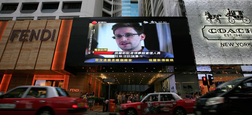 An outdoor screen in Hong Kong shows an Edward Snowden interview.