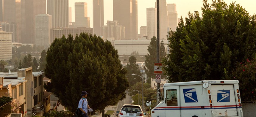 A 25-year veteran U.S. mail carrier walks his route in Los Angeles. 