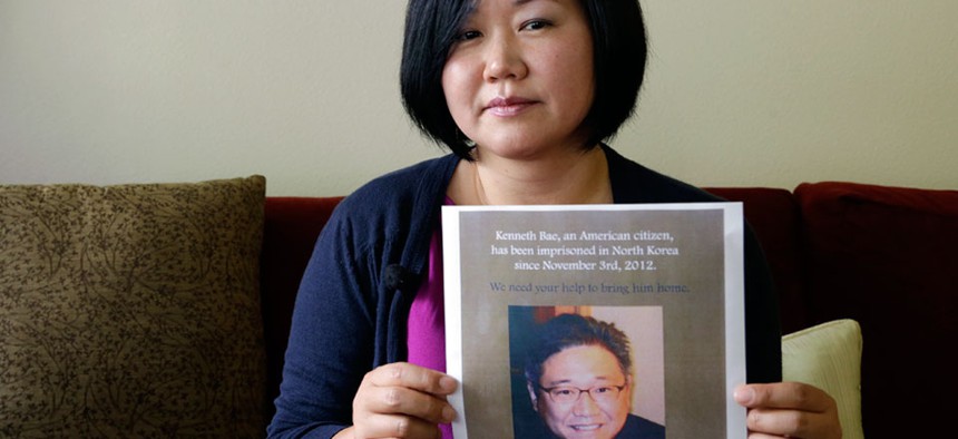Terri Chung holds a notice of a prayer vigil for her brother, Kenneth Bae.