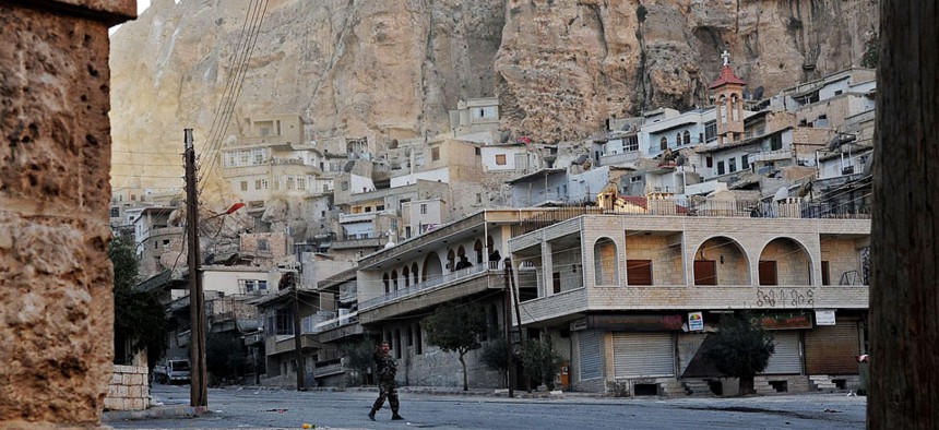 A Syrian government solider  in Maaloula in the midst of fighting in the village.