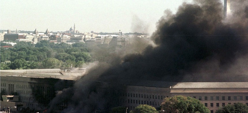 A helicopter flies over the burning Pentagon Tuesday, Sept. 11, 2001.