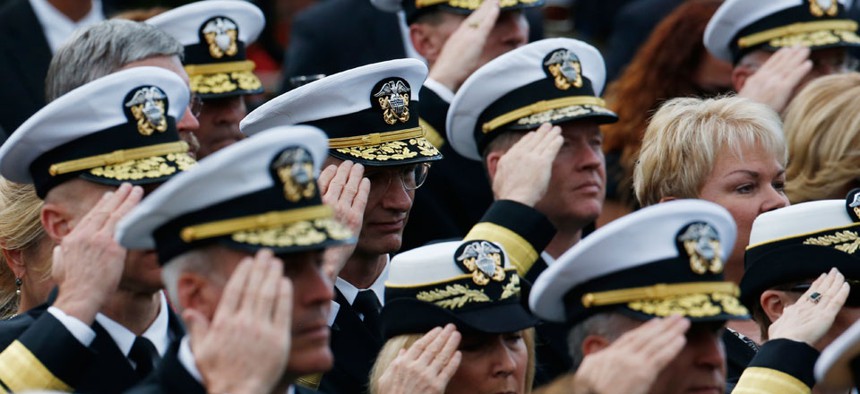Navy personnel salute during the playing of "Taps" at a memorial service for the victims of the Washington Navy Yard shooting.
