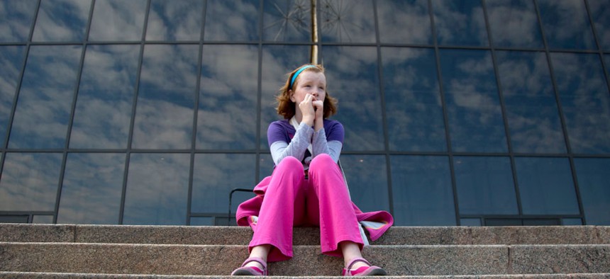 Fay Wagstaff of El Paso, Texas. sits on the front steps of the closed Smithsonian National Air and Space Museum. Many Smithsonian employees were deemed "nonessential" during the shutdown.