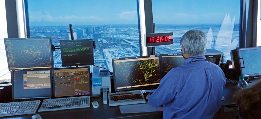 An air traffic controller works in the control tower at Los Angeles International Airport