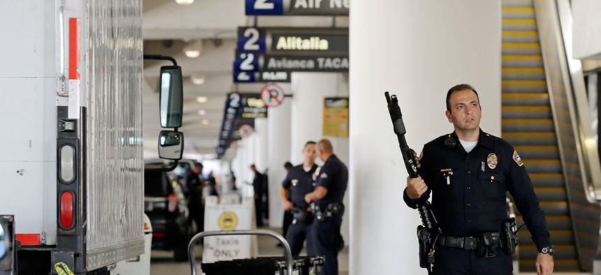 Police stand guard in Terminal 2 at Los Angeles International Airport on Friday, Nov. 1, 2013.