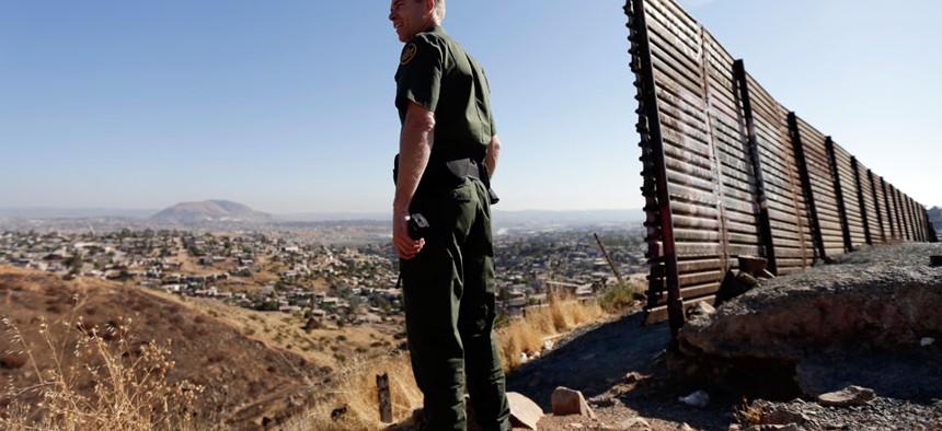 A US Border Patrol agent looks out over Tijuana, Mexico. 