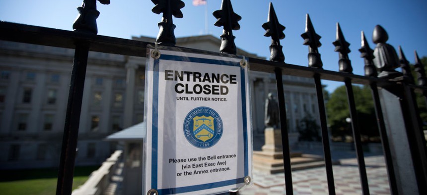 A sign outside of Treasury indicates the closure of one entrance due to the government shutdown Oct. 1.