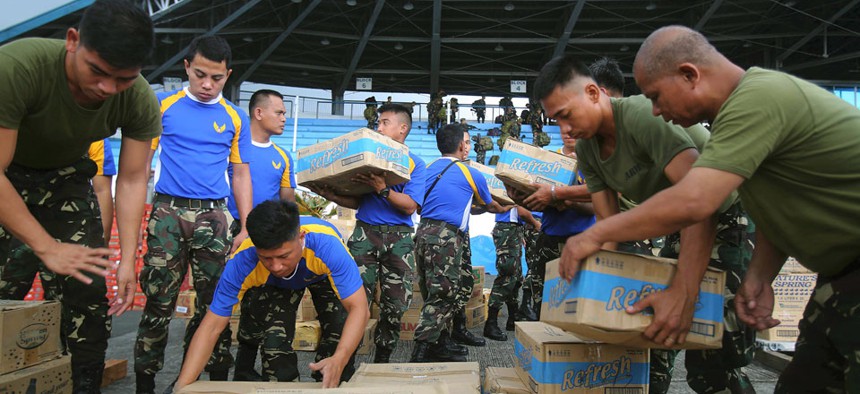 Philippine soldiers pack relief supplies for victims of Typhoon Haiyan at Villamor Airbase.