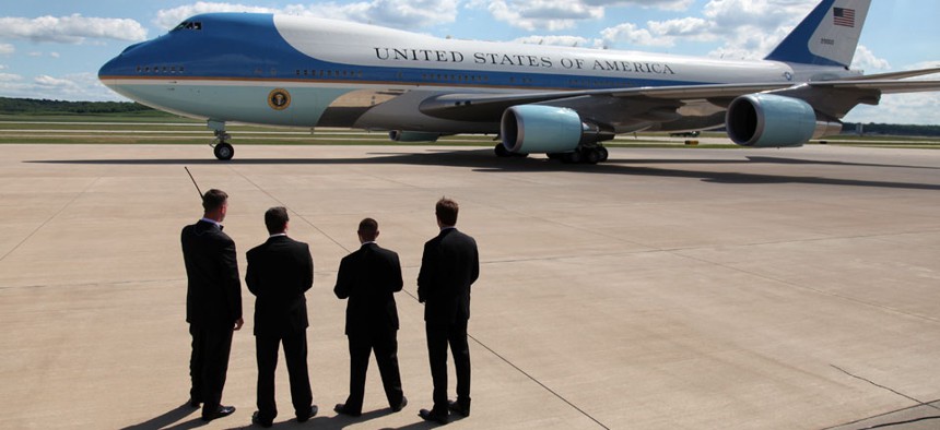 Secret Service agents watch as President Barack Obama leaves on Air Force One.