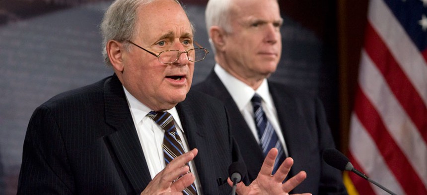 Senate Armed Services Committee Chairman Sen. Carl Levin, D-Mich., left, accompanied by Sen. John McCain, R-Ariz. ranking Republican on the committee.