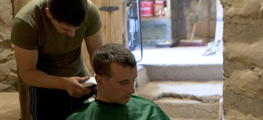 A Marine gets his hair cut at Observation Post Athens, Helmand province, Afghanistan in November.