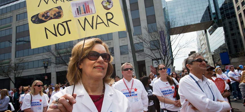 Lorraine Gudas, chair of pharmacology at Weill Cornell Medical College, and others, participate in a "Rally for Medical Research," Monday, April 8, 2013, in Washington.