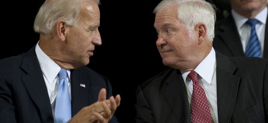 Robert Gates and Joe Biden sat together during the United States Forces-Iraq change of command ceremony in 2010