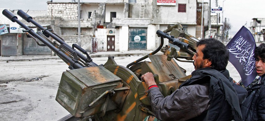 ree Syrian Army fighters sit behind their antiaircraft machine gun in Aleppo last year.