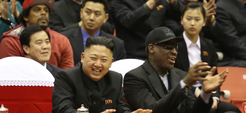 Rodman and Kim Jong-un watch a basketball game in North Korea in 2013.
