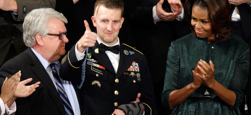 Army Ranger Sgt.1st Class Cory Remsburg acknowledges applause from first lady Michelle Obama and others during President Barack Obama's State of the Union address. 