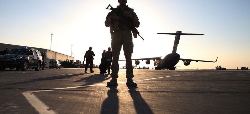 A solider stands guard near a military aircraft in Kandahar, Afghanistan.