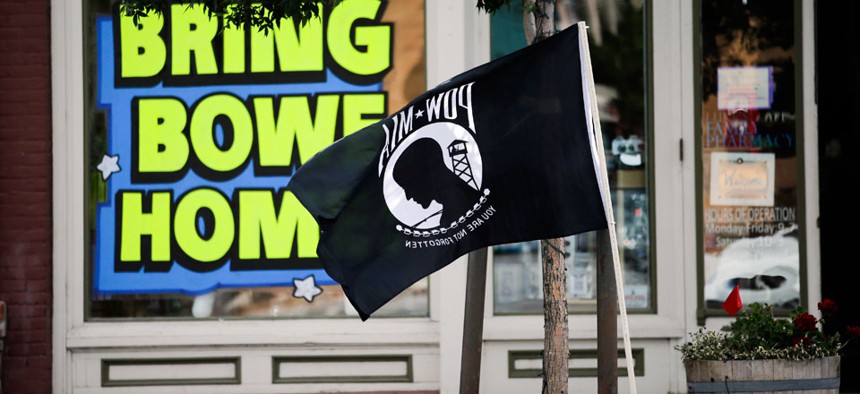 A POW-MIA flag flies in front of a pharmacy displaying a sign in support of bringing home U.S. Army Sgt. Bowe Bergdahl, who is currently being held captive by the Taliban in Afghanistan.