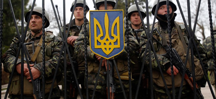 Ukrainian soldiers guard a gate of an infantry base in Privolnoye, Ukraine.