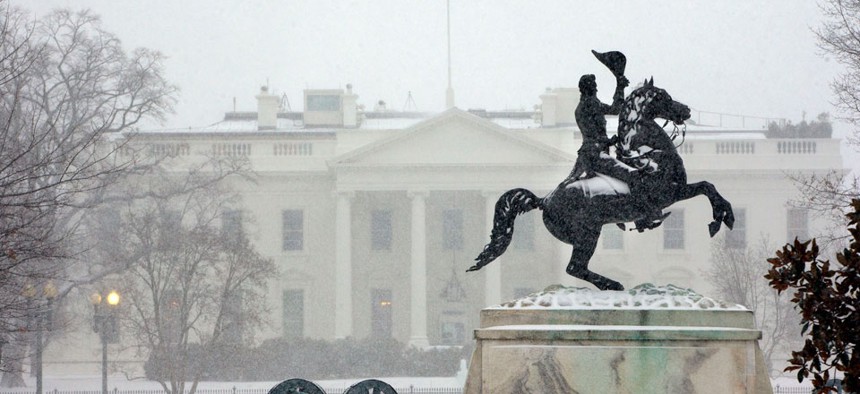 Snow falls on a statue of Andrew Jackson in Lafayette Park Monday.
