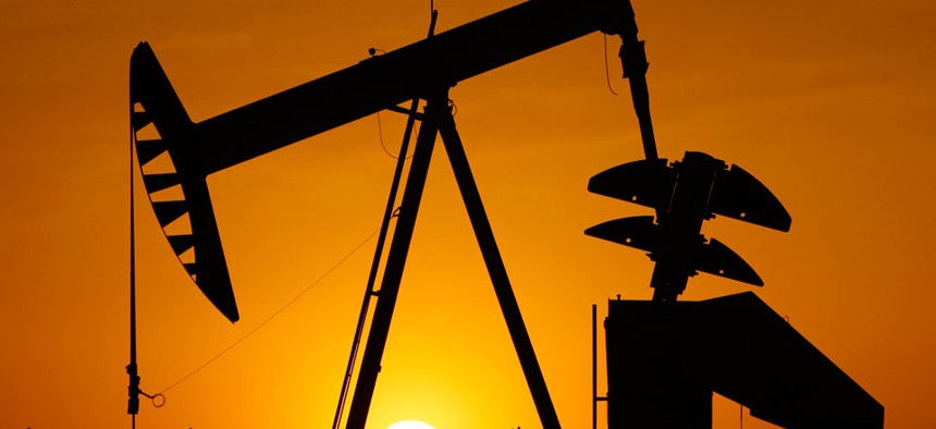 A pumpjack is silhouetted against the setting sun in Oklahoma City.