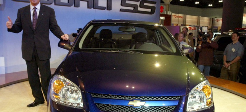 Gary Cowger, president of GM North America, stands beside a new 2005 Chevrolet Cobalt in 2003.