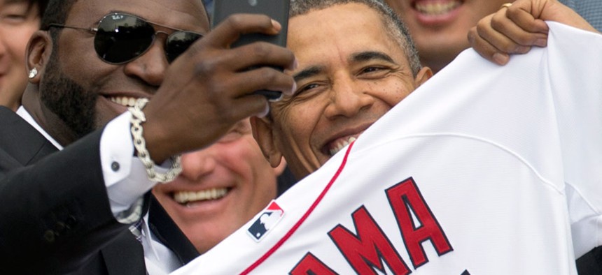 Boston Red Sox designated hitter David "Big Papi" Ortiz takes a selfie with President Barack Obama during a ceremony on the South Lawn of the White House.