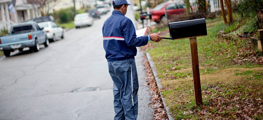 A postal worker delivers mail in Atlanta in 2013.
