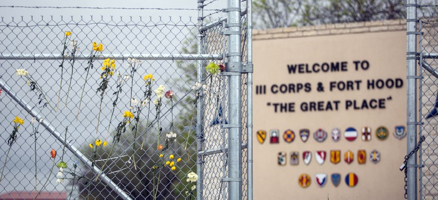 Flowers decorate a fence outside of Fort Hood's east gate on Sunday, April 6, 2014, in Killeen, Texas, in honor of those killed and wounded in the Fort Hood shooting on April 2. 
