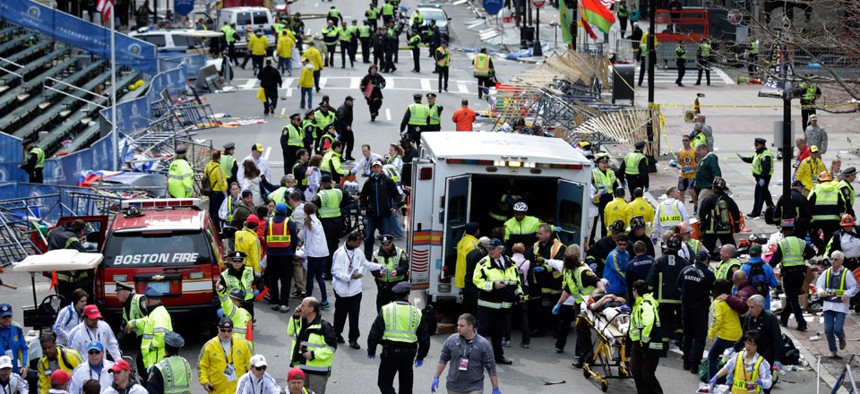 Medical workers aid injured people near the finish line of the 2013 Boston Marathon following two bomb explosions in 2013.