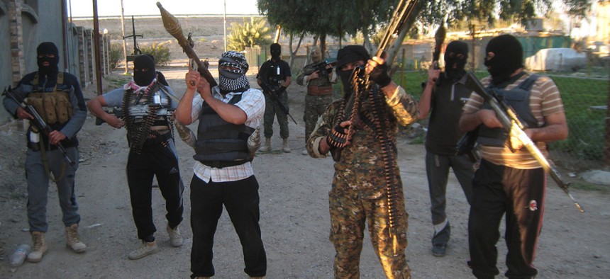 Anti-government gunmen hold their weapons as they patrol in Fallujah last month.