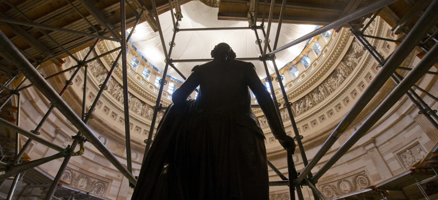 The statue of George Washington is seen surround by scaffolding after safety netting was installed around the inside the Capitol Rotunda.