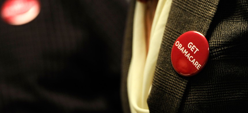 Associates at Community Health Center wear buttons reading "Get Obamacare" in October.