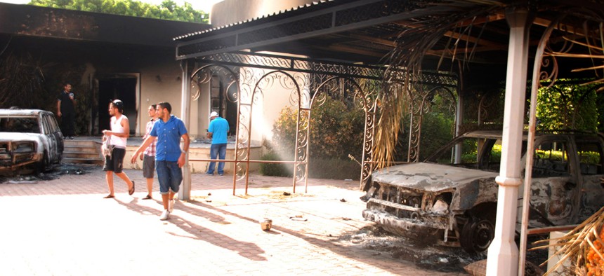 Libyans walk on the grounds of the gutted U.S. consulate in Benghazi in 2012.