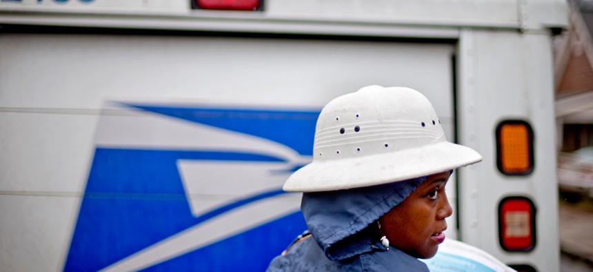 Jamesa Euler, delivers mail in the rain in Atlanta in 2013.