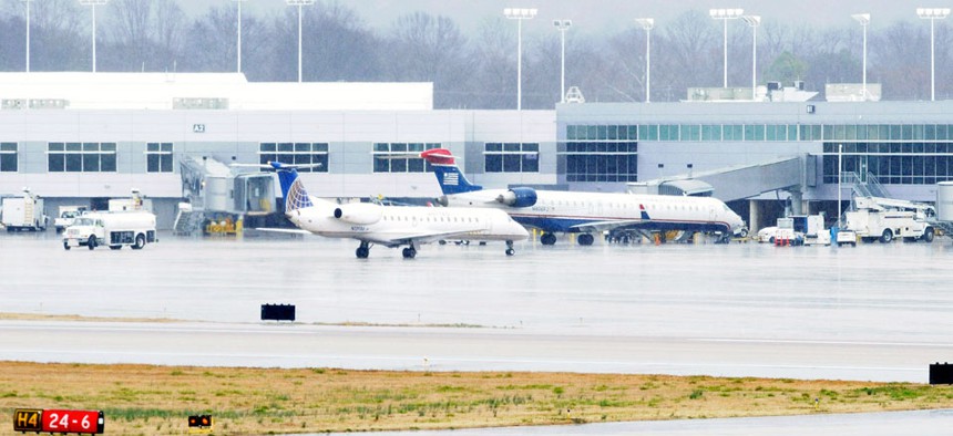  A United Express jet operated by ExpressJet pulls into the terminal after landing in rain on the main runway at Birmingham-Shuttlesworth International Airport.