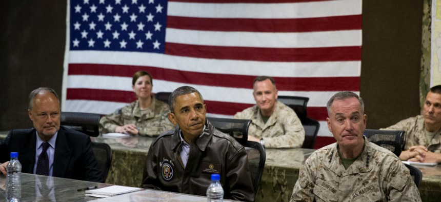 President Barack Obama, center, gets a briefing after arriving at Bagram Air Field for an unannounced visit.