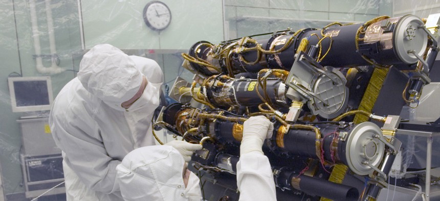 Researchers work in the  Sun Earth Connection Coronal and Heliospheric Investigation (SECCHI) instrument being built at the Naval Research Laboratory in Washington, DC