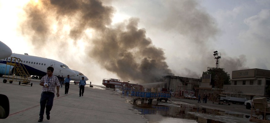 Smoke rises above the Jinnah International Airport where security forces battled militants in Karachi, Pakistan.  