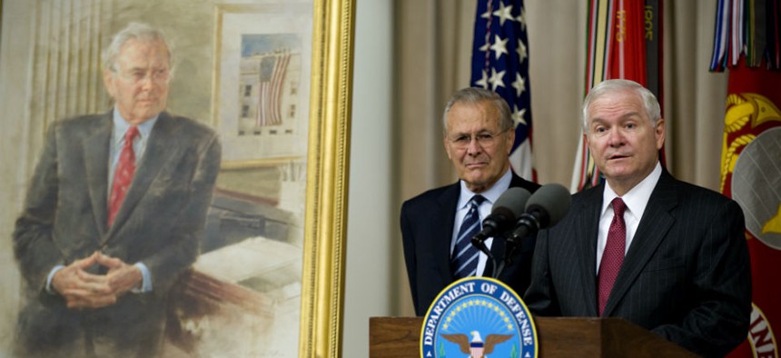 Defense Secretary Robert Gates, right, addresses the audience while former Defense Secretary Donald Rumsfeld looks on during Rumsfeld's portrait unveiling ceremony at the Pentagon, in 2010.