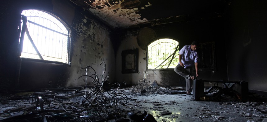 A Libyan man looks around the burnt U.S. Consulate in Benghazi in 2012.